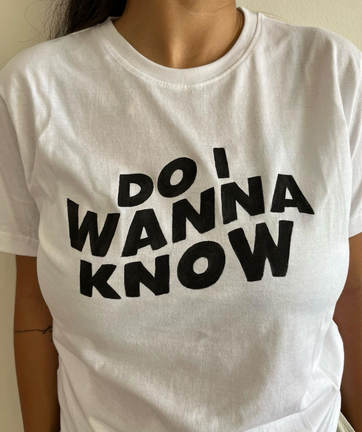 Full view of a unique hand-painted "Do I Wanna Know" t-shirt, featuring the song title on a white t shirt.