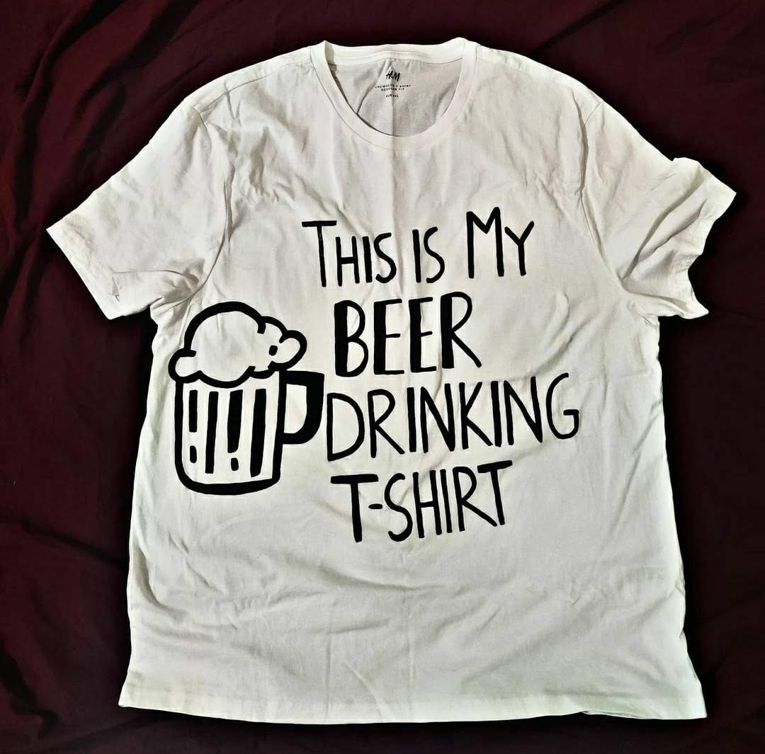 Full view of a unique hand-painted "This Is My Beer Drinking T-Shirt" on a white cotton beer t shirt, featuring a black beer mug design.