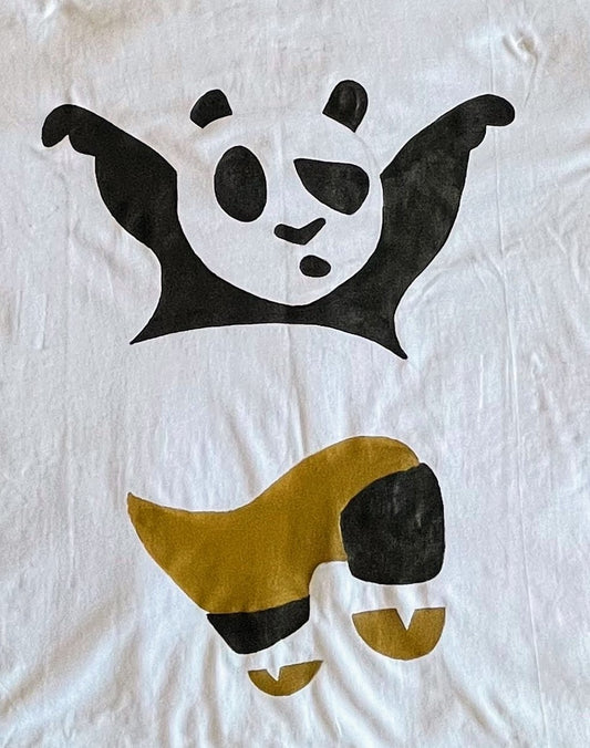 Close-up of the detailed hand-painted Po design on a Kung Fu Panda t-shirt, showcasing the vibrant artistic brushwork.
